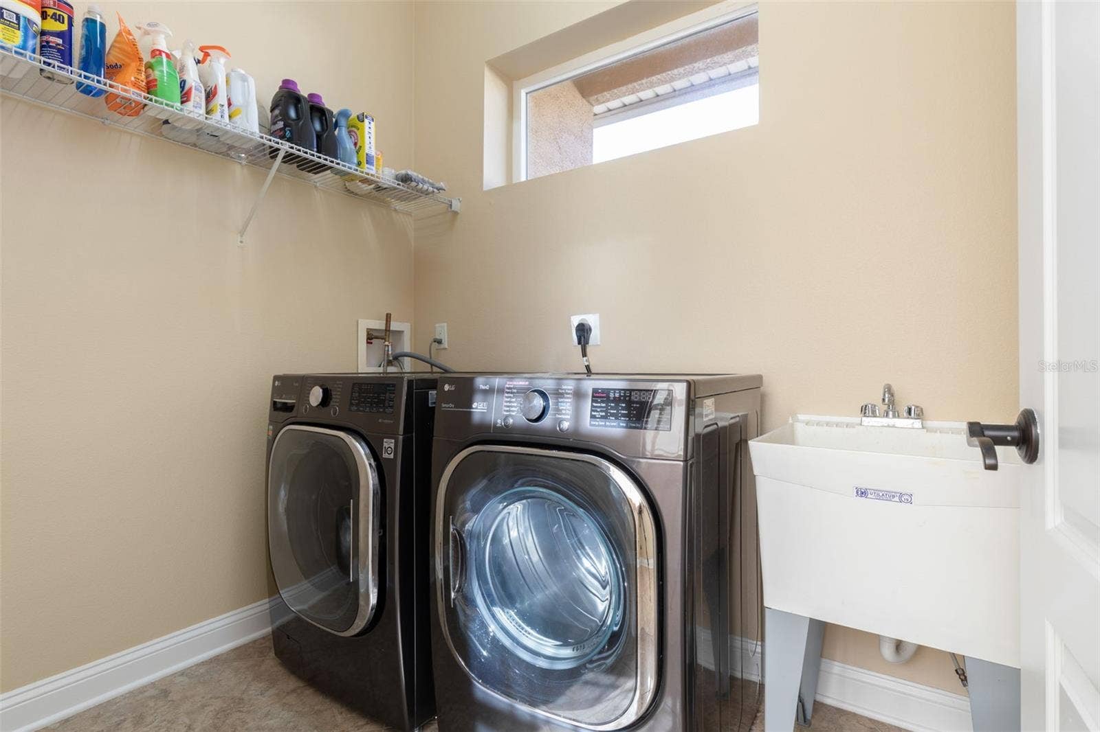 25 EMERALD LAKE COURT, Palm Coast, FL 32137 Convenient Indoor Laundry Room with Washer, Dryer & Utility Sink