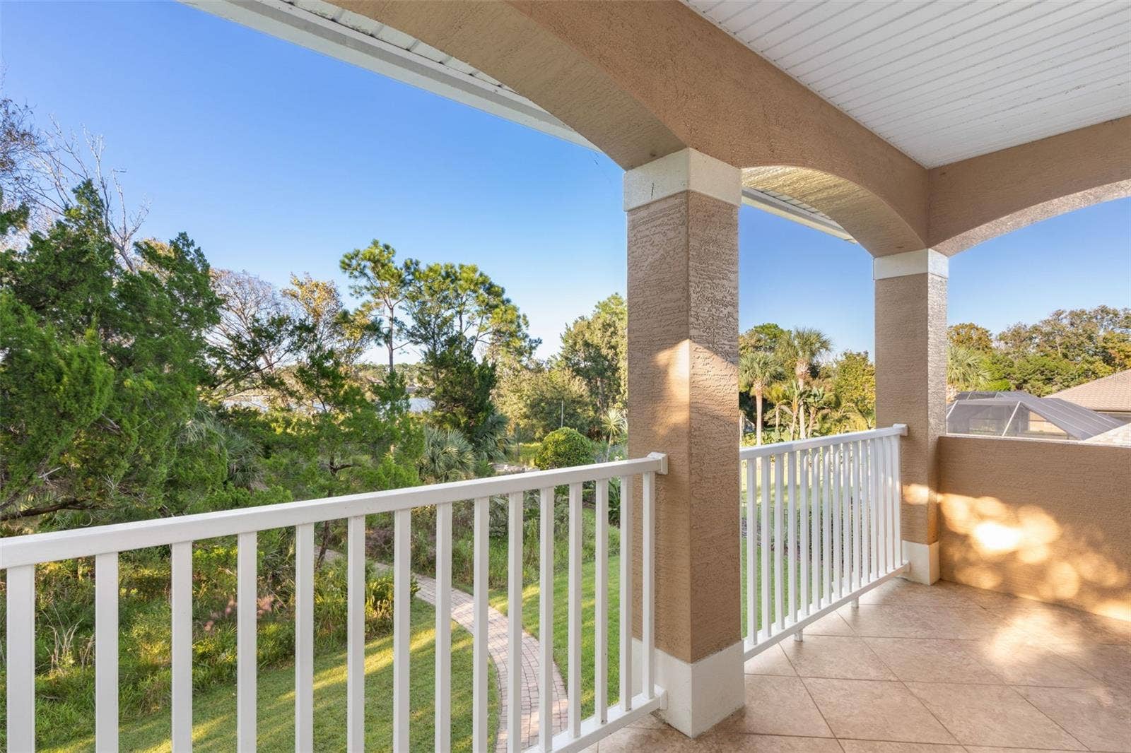25 EMERALD LAKE COURT, Palm Coast, FL 32137 Step onto the private covered balcony and enjoy the peaceful natural surroundings, with glimpses of Emerald Lake through the trees.