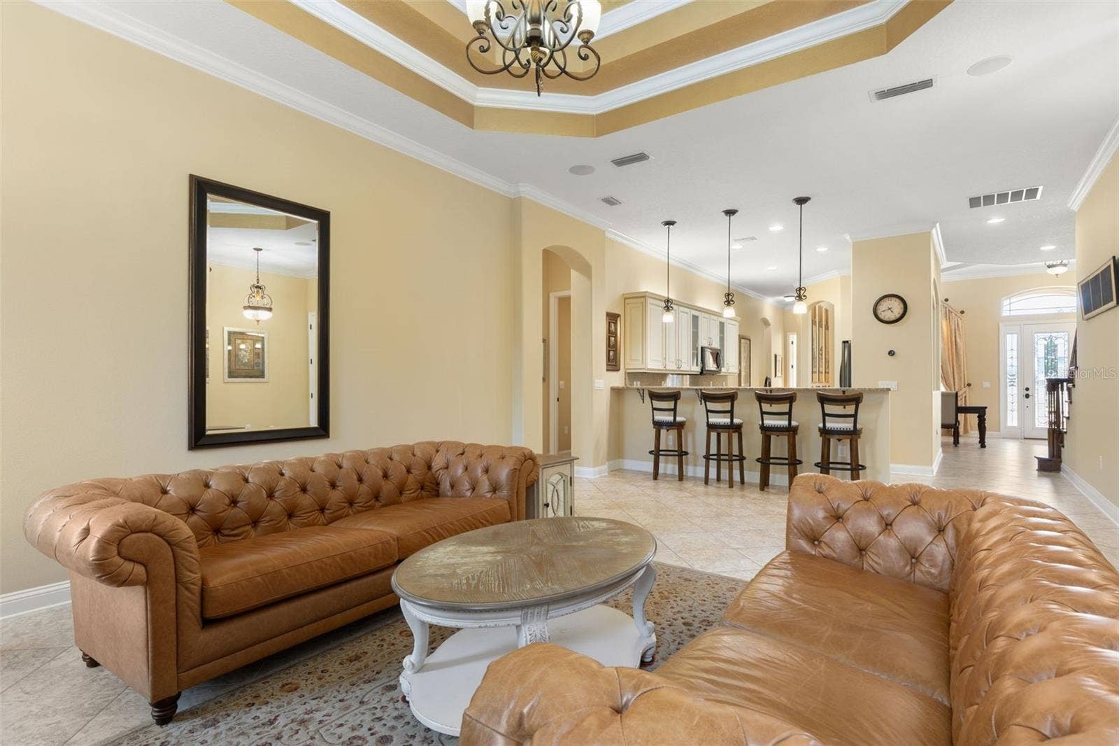25 EMERALD LAKE COURT, Palm Coast, FL 32137 An open, welcoming layout offers a view toward the home's front entrance, showcasing the thoughtful connection between living spaces.