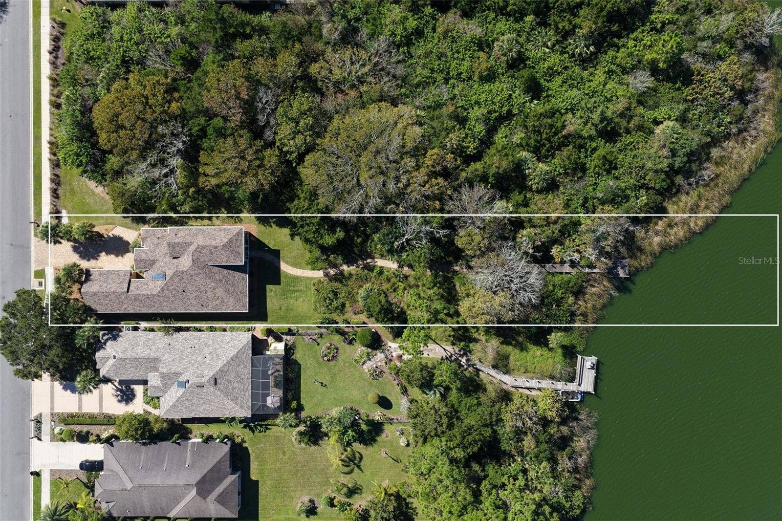 25 EMERALD LAKE COURT, Palm Coast, FL 32137 Overhead aerial showcasing the property's spacious 0.57-acre setting, natural conservation landscape, and private walkway leading to Emerald Lake.