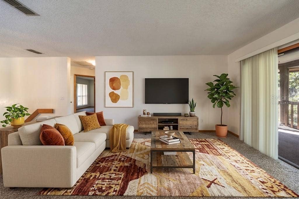 VIRTUALLY STAGED: Living Area With Sliders That Open Into The Screened Patio