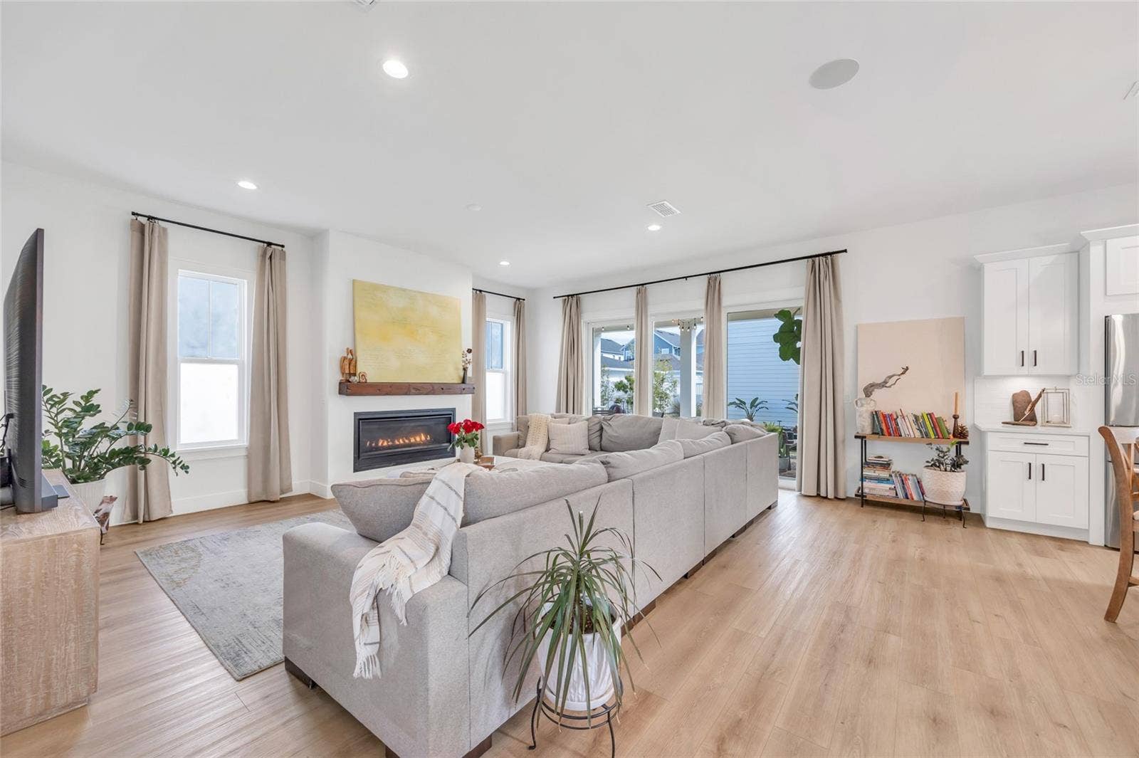 906 ALLENDALE LANE, Winter Garden, FL 34787 Inviting open concept living room centered around beautiful gas fireplace, perfect for every day living