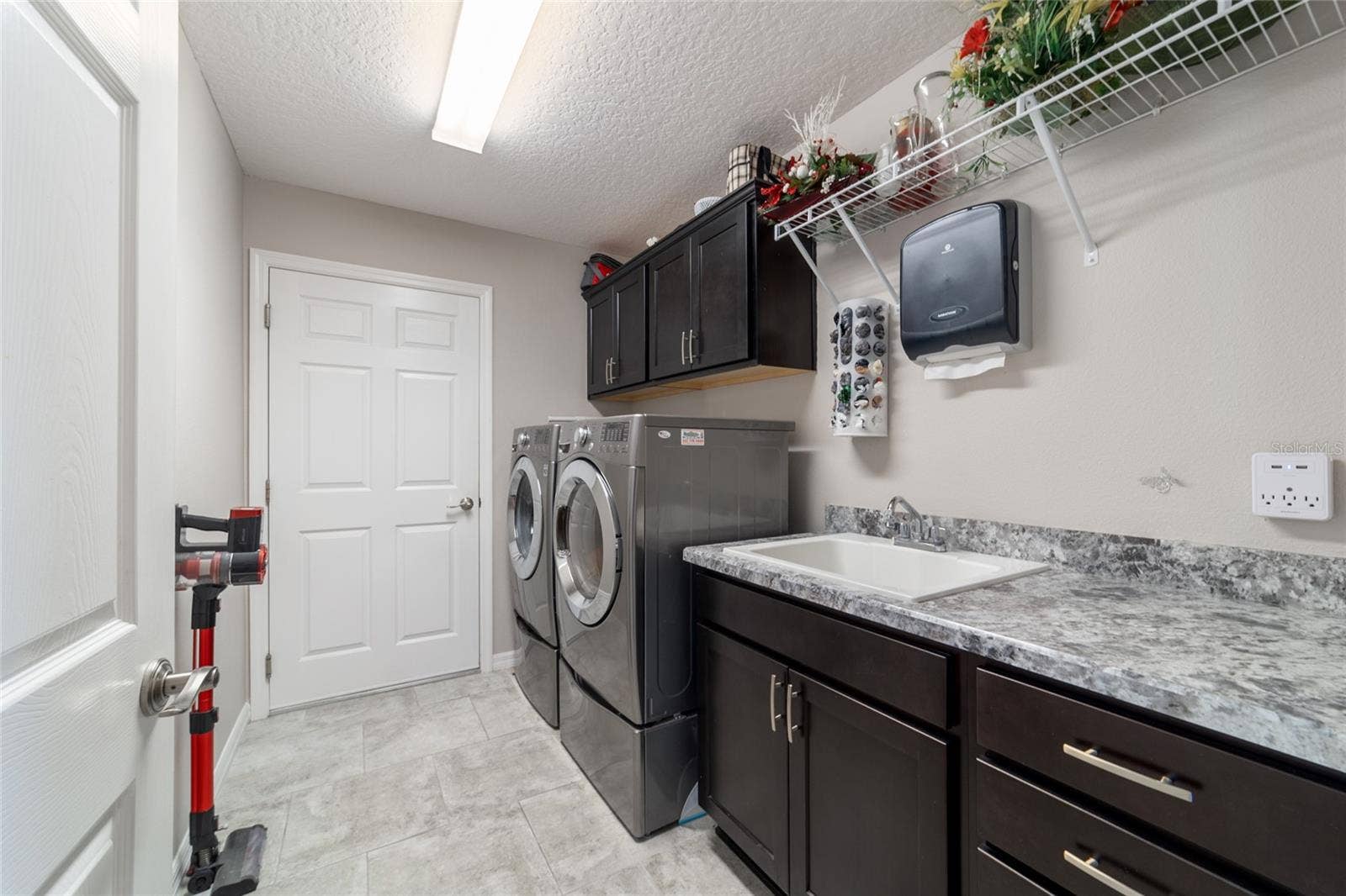 Interior laundry with sink and cabinets