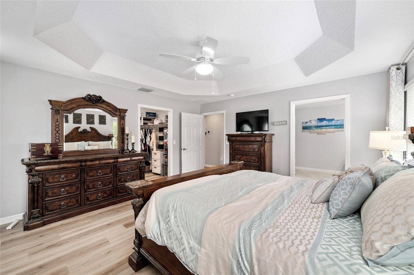 The space is elevated with a tray ceiling and overhead lighting