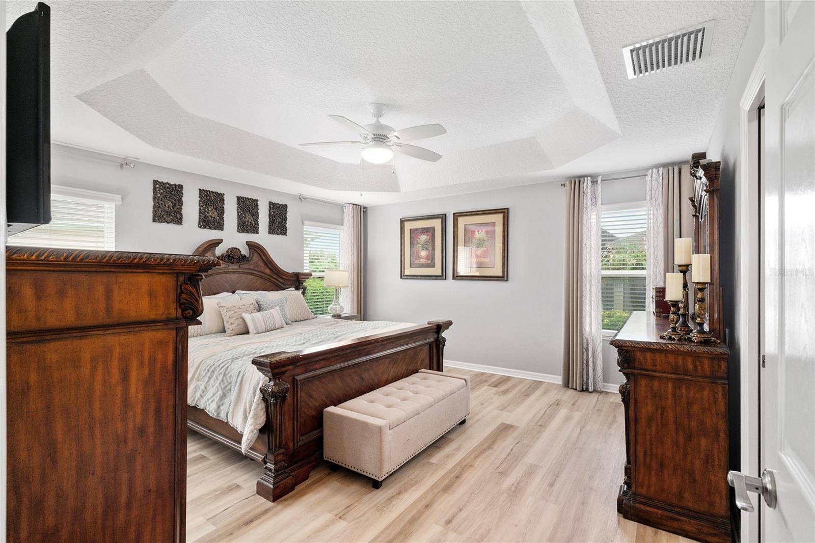 Spacious primary bedroom comfortably accommodates a king size bed