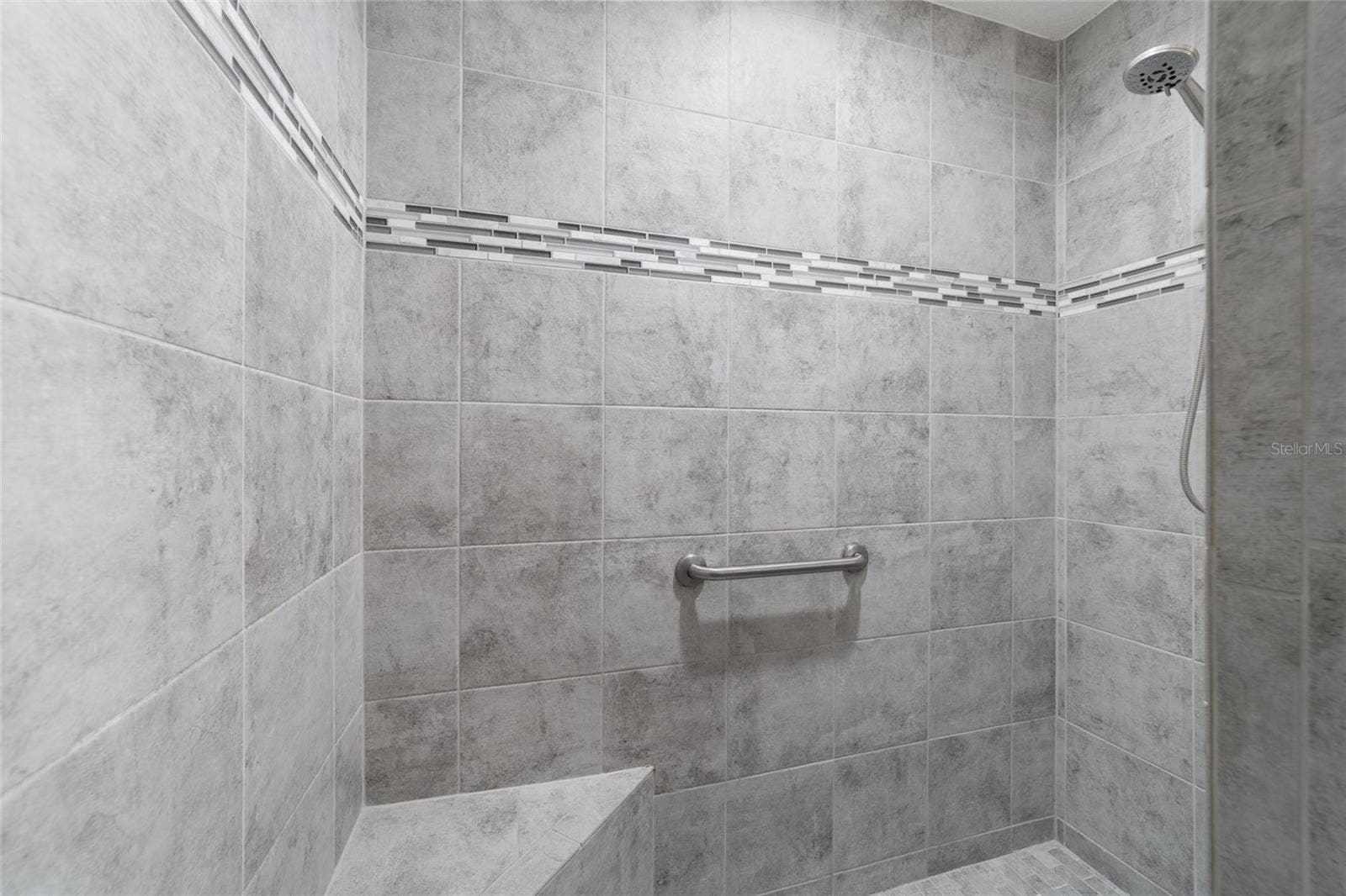 Tiled Roman shower in the primary bath