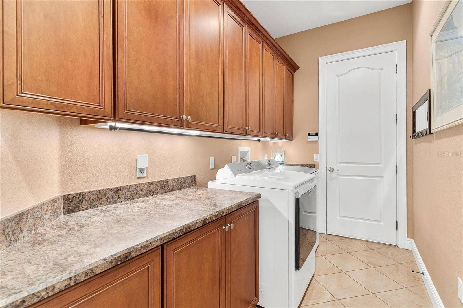 Inside Laundry room with lots of cabinets and folding counter!