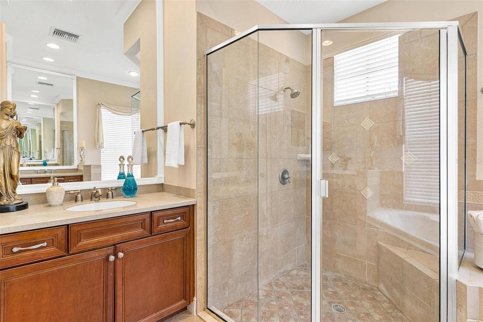 Separate glass walk in shower plus raised vanity....