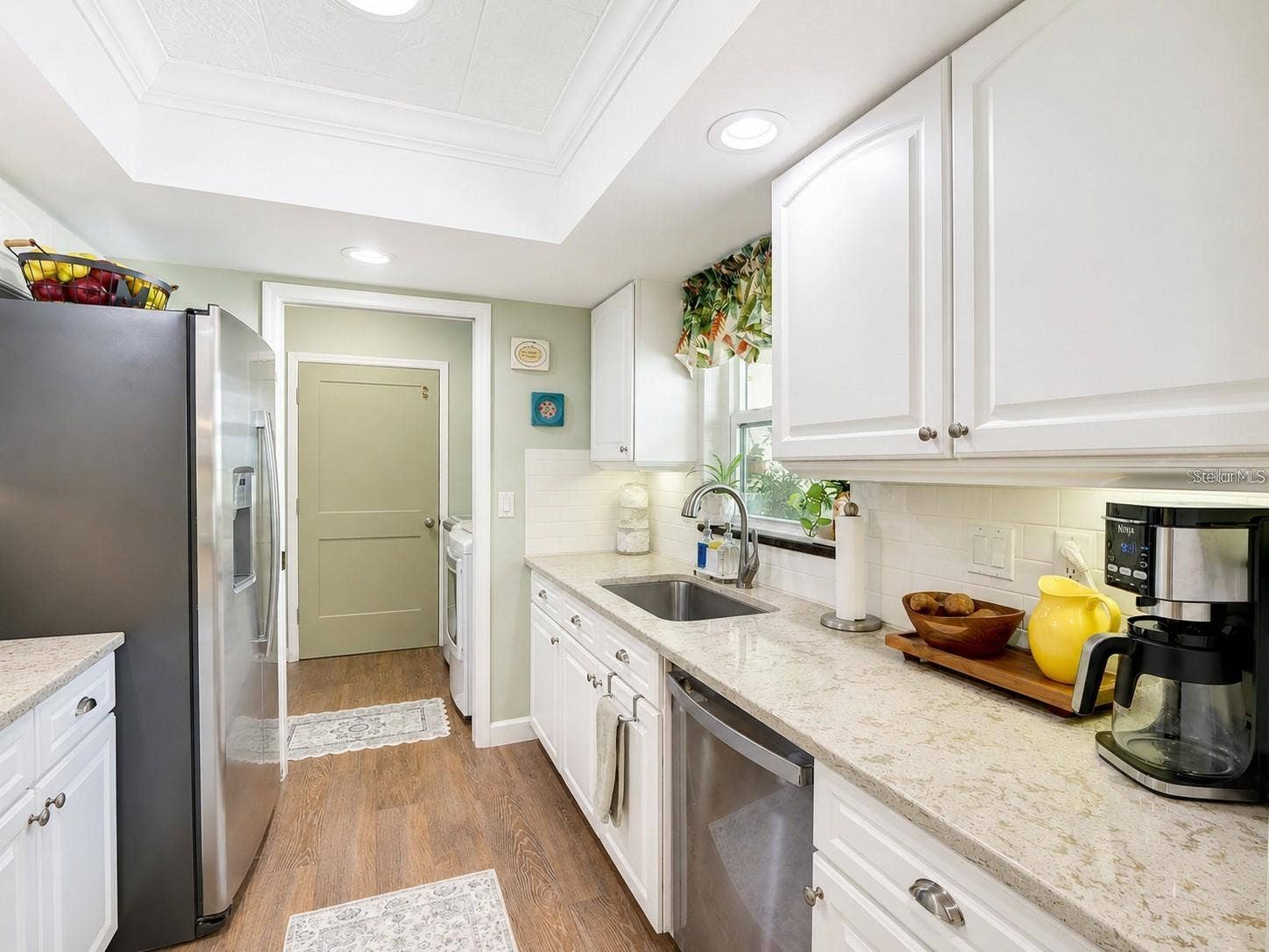 100 S TREMAIN STREET, #G2, Mount Dora, FL 32757 Kitchen: Pocket Door to the Pantry, W/D, & Garage Entry