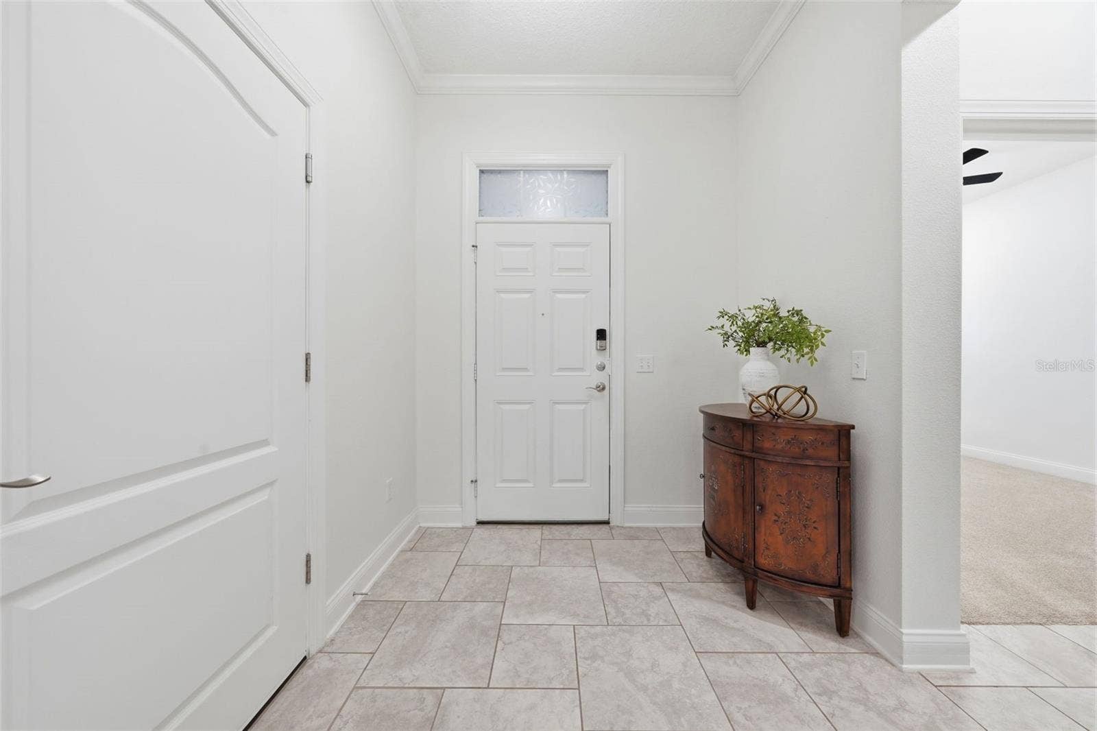 16716 ABBEY HILL COURT, Clermont, FL 34711 Foyer with garage entry to the left