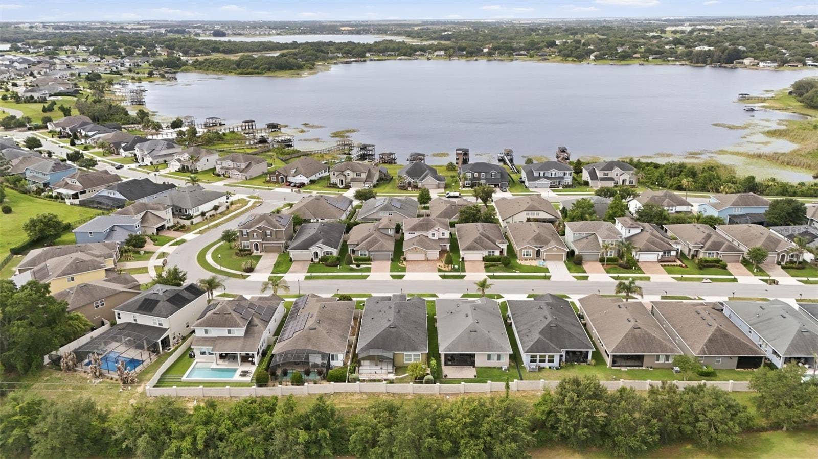 16716 ABBEY HILL COURT, Clermont, FL 34711 Aerial view of community and John's Lake