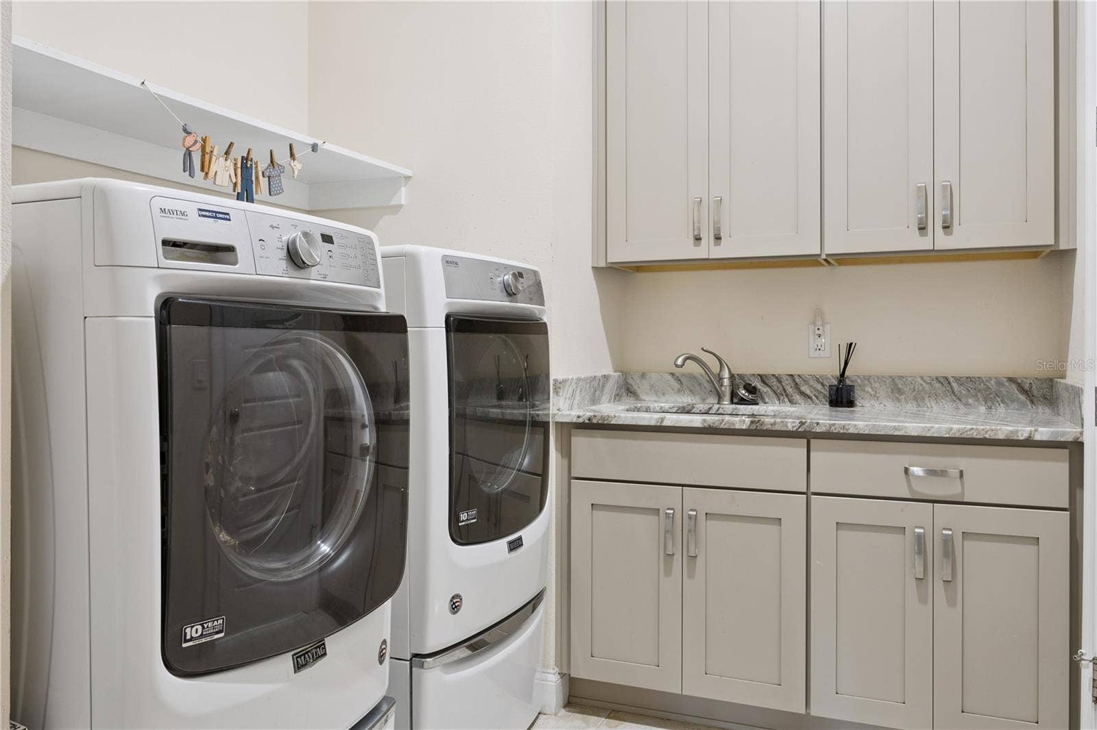 9219 SAN JOSE BOULEVARD, Howey In The Hills, FL 34737 Laundry with sink, custom, cabinets, granite countertops, washer & dryer.