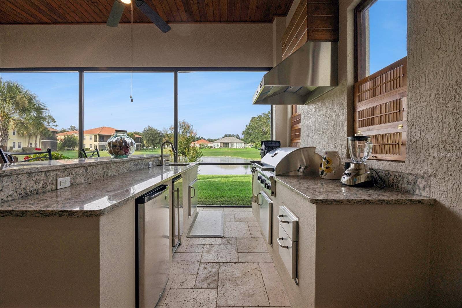 9219 SAN JOSE BOULEVARD, Howey In The Hills, FL 34737 Sink, gas grill & small refrigerator. Beautiful view of the pond.