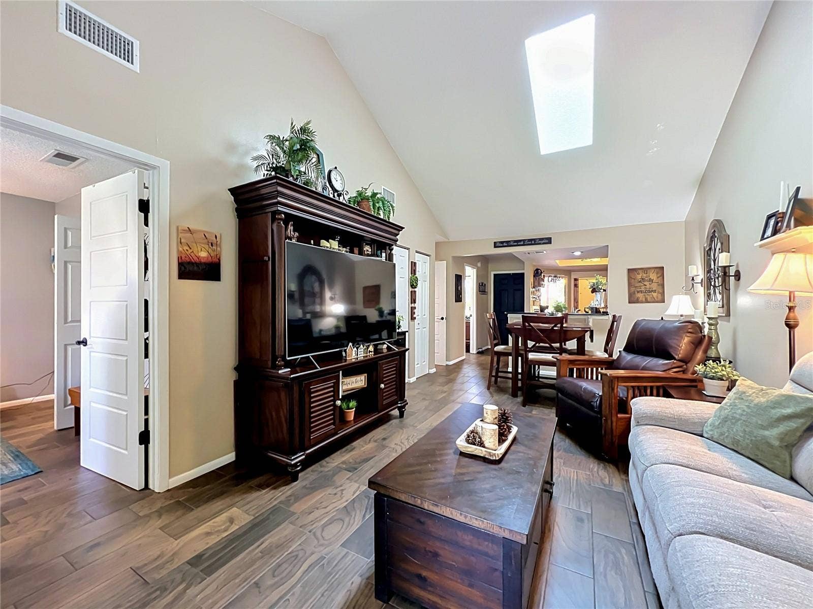 4300 BAYWOOD BOULEVARD, #C106, Mount Dora, FL 32757 Living Room and Entry to Primary Bedroom