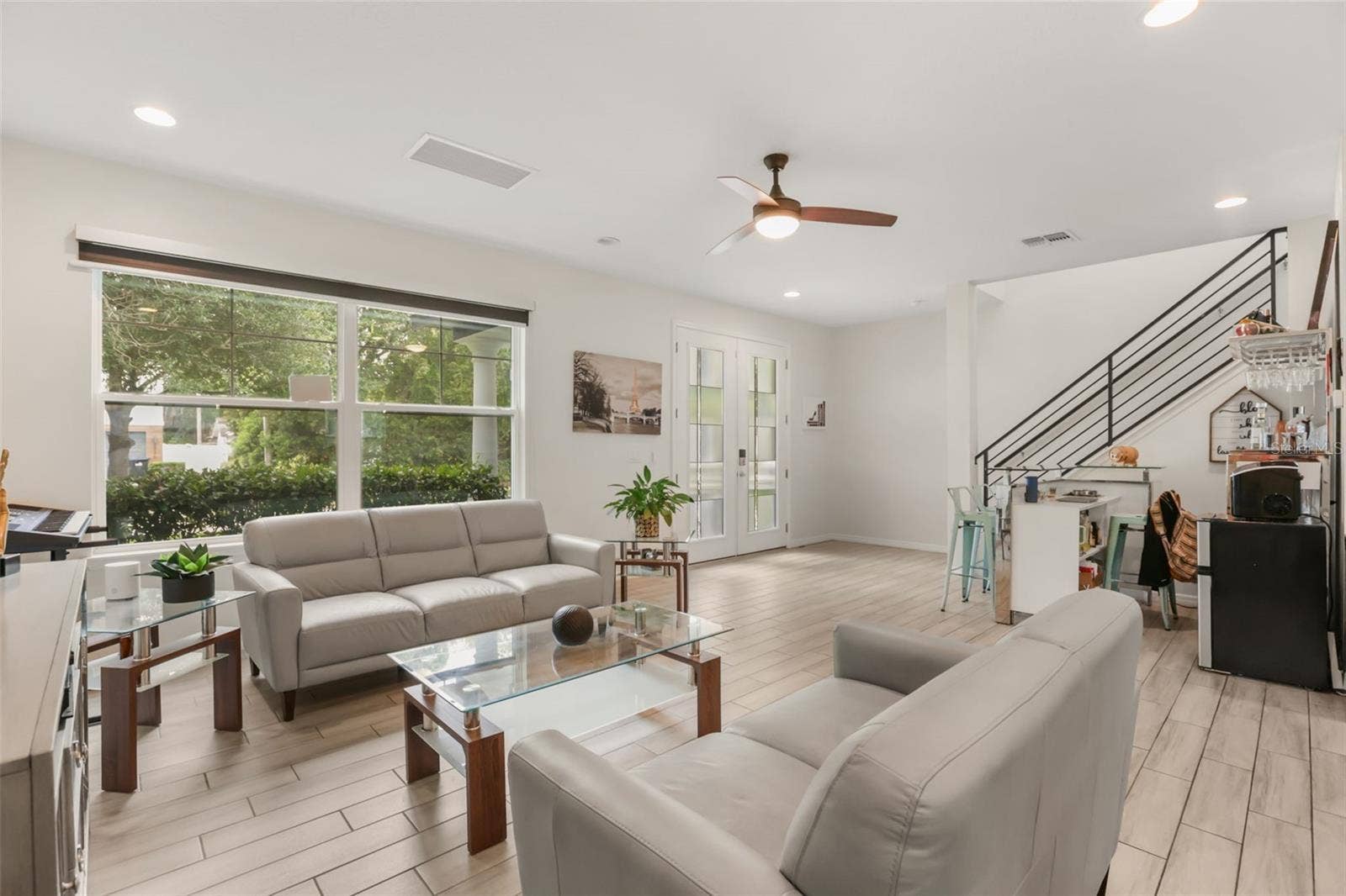 Inviting living room with abundant natural light, high ceilings, and an open layout that creates a bright and welcoming atmosphere.