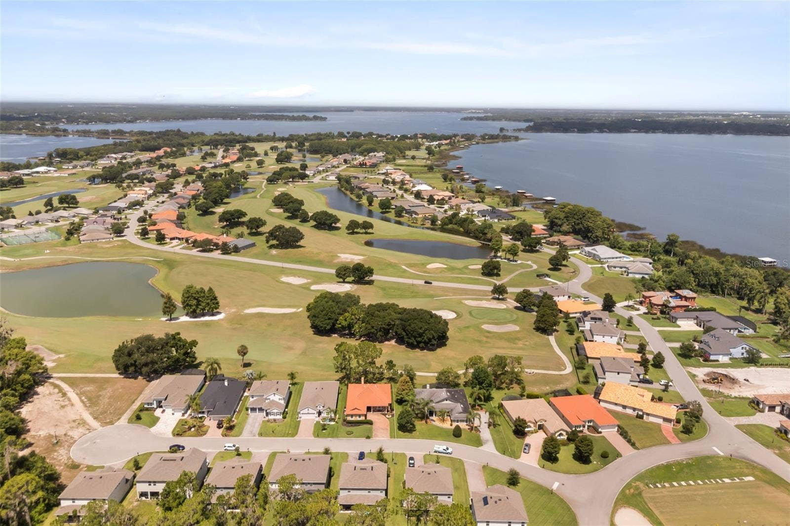 Aerial showing Deer Island: bottom right Driving Range, right Lake Dora, Top left causeway between Lake Dora & Lake Beauclair