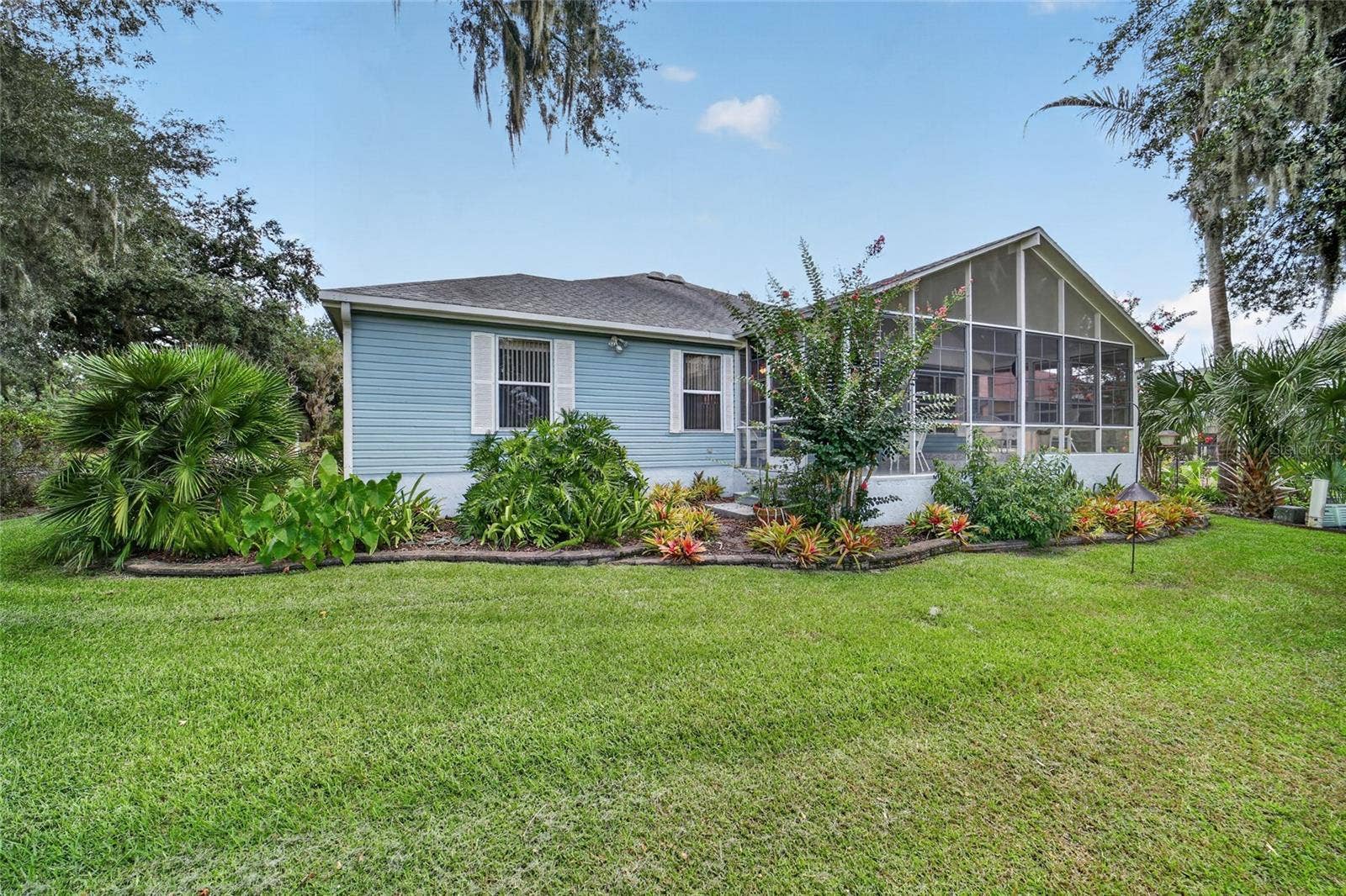 1230 DESILVA STREET, The Villages, FL 32159 Back of House with Lanai from Golf Course