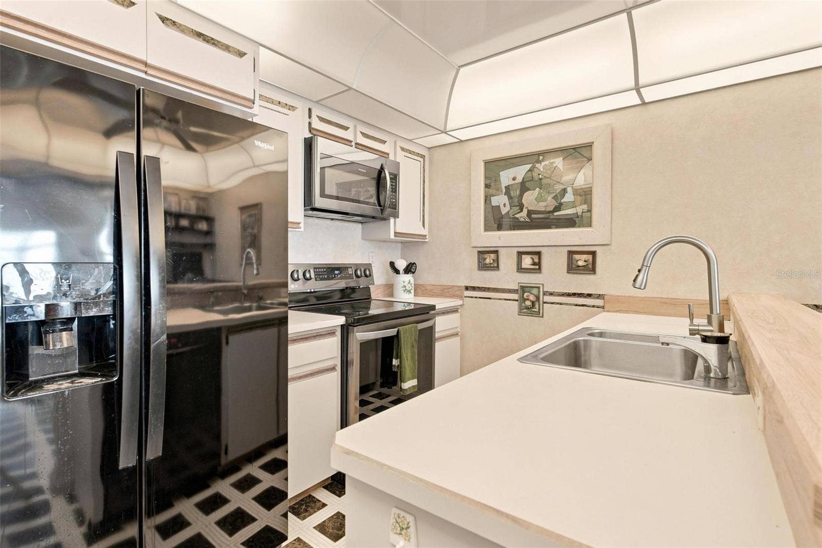 395 S ATLANTIC AVENUE, #402, Ormond Beach, FL 32176 Kitchen features a dinette area and overlooks the dining and living area.