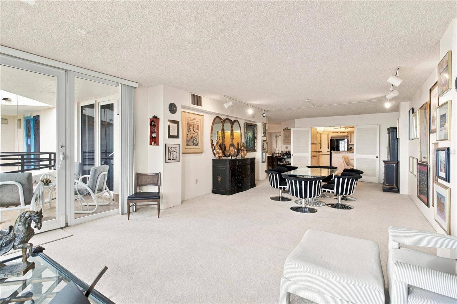 395 S ATLANTIC AVENUE, #402, Ormond Beach, FL 32176 Open Living Space. Dining and Living Area overlook Kitchen and has sliders leading to balcony with ocean view.