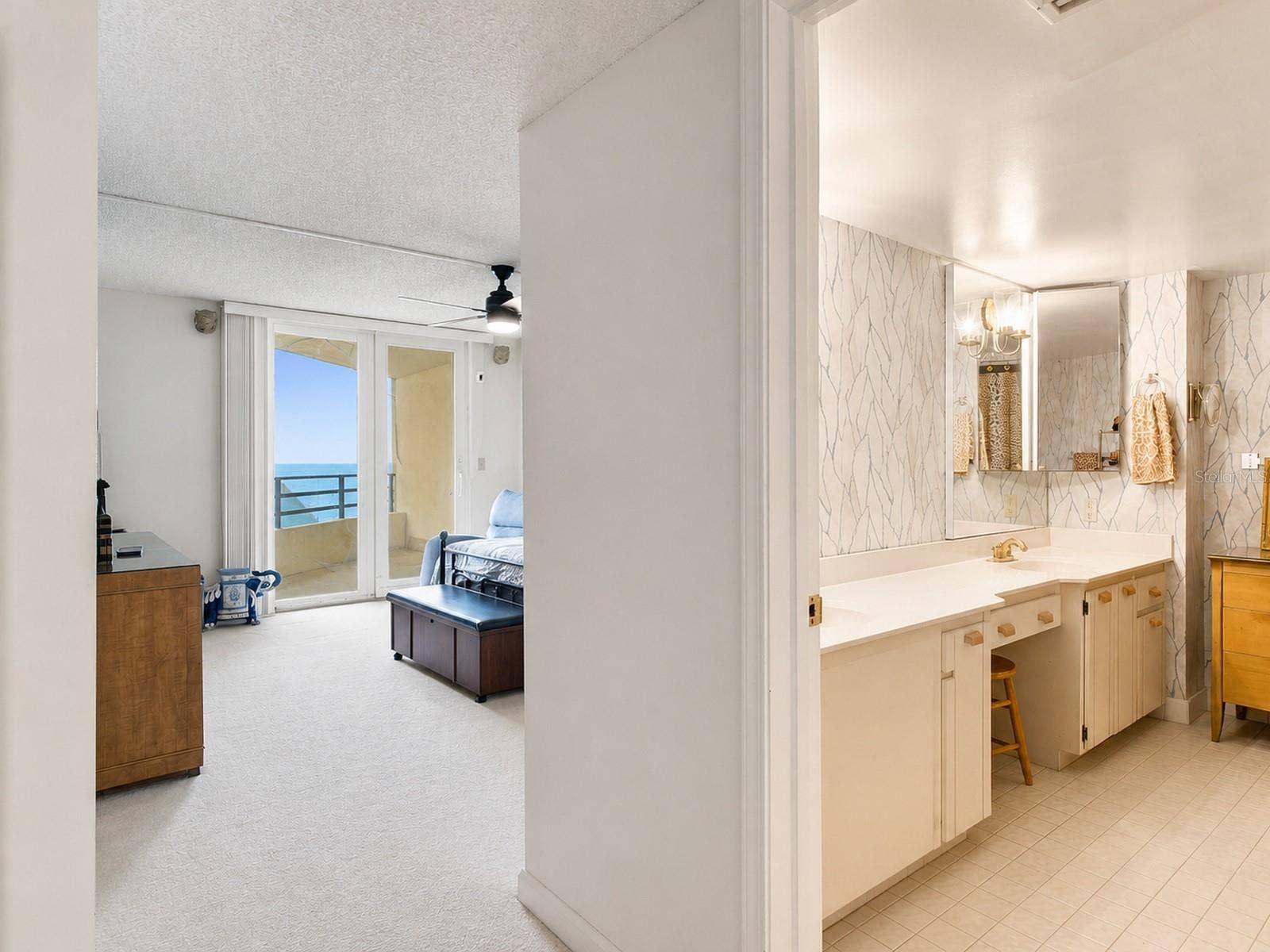 395 S ATLANTIC AVENUE, #402, Ormond Beach, FL 32176 Primary bedroom suite features primary bath, walk in closet, and balcony with ocean views.