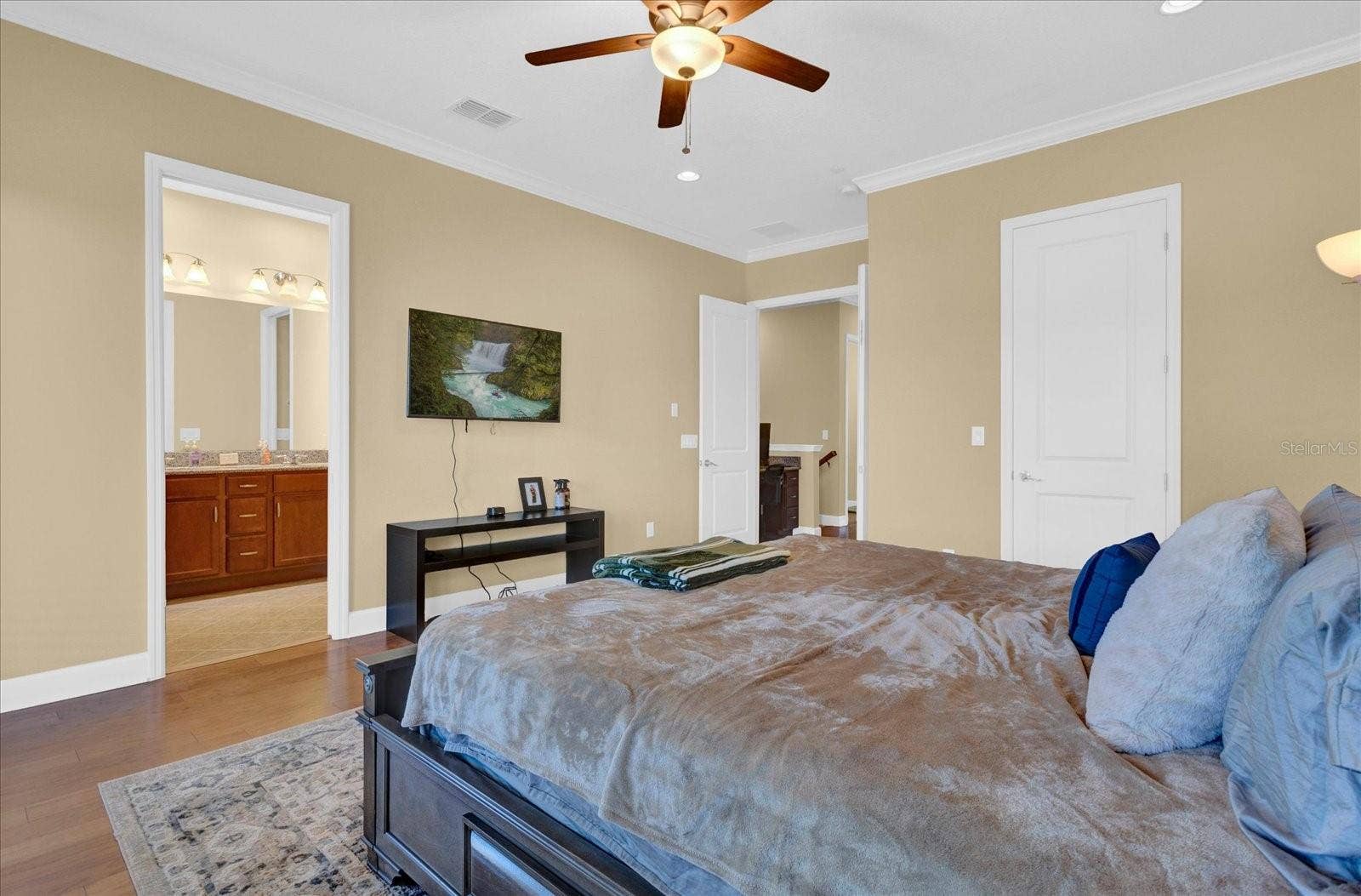 Comfortable bedroom retreat with ceiling fan and direct ensuite access.