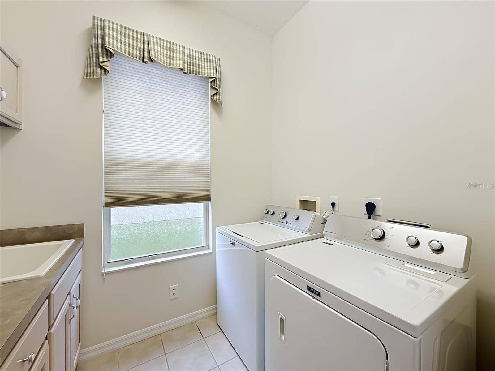 Laundry room, with cabinets and laundry sink. Gas dryer option