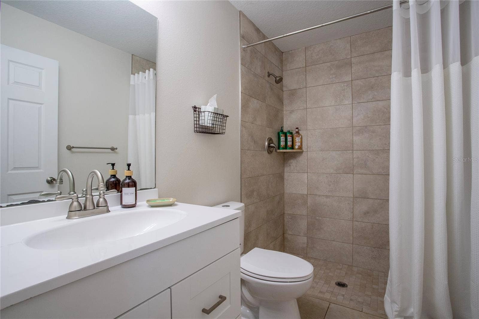 Primary bathroom with a shower and single vanity