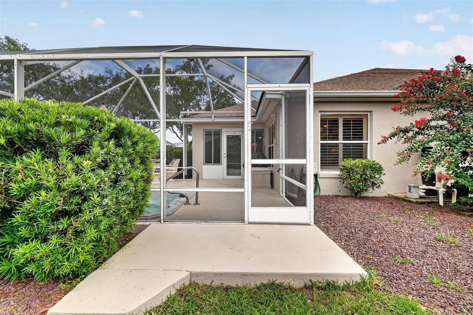 1218 CAMERO DRIVE, Lady Lake, FL 32159 Side of pool area with small grilling patio