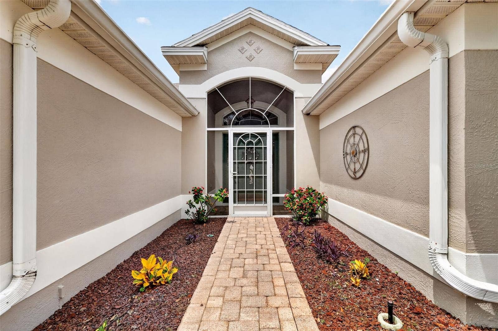 1218 CAMERO DRIVE, Lady Lake, FL 32159 Paver walk leads to the screened in entrance.