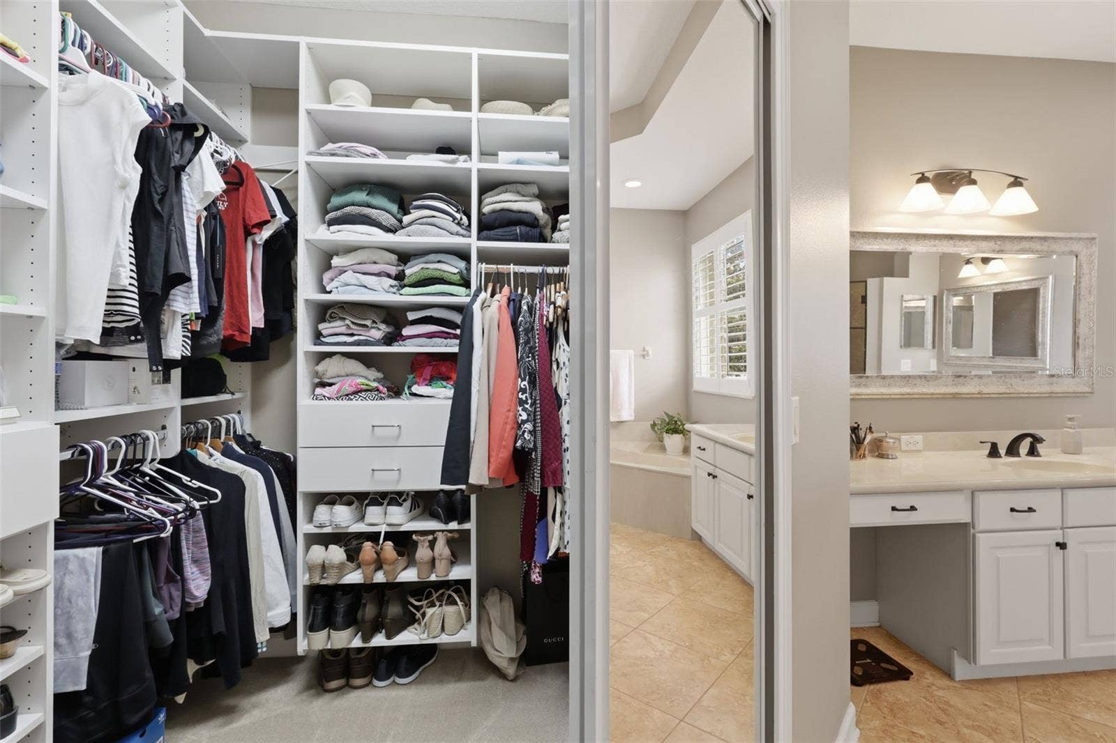 426 DUFF DRIVE, Winter Garden, FL 34787 One of the 2 primary bedroom custom closets.