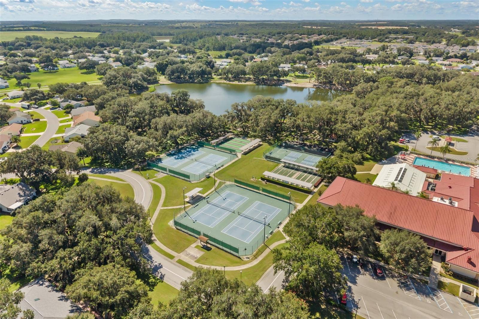 Clubhouse with outdoor pool, tennis, pickle ball and bocce ball courts