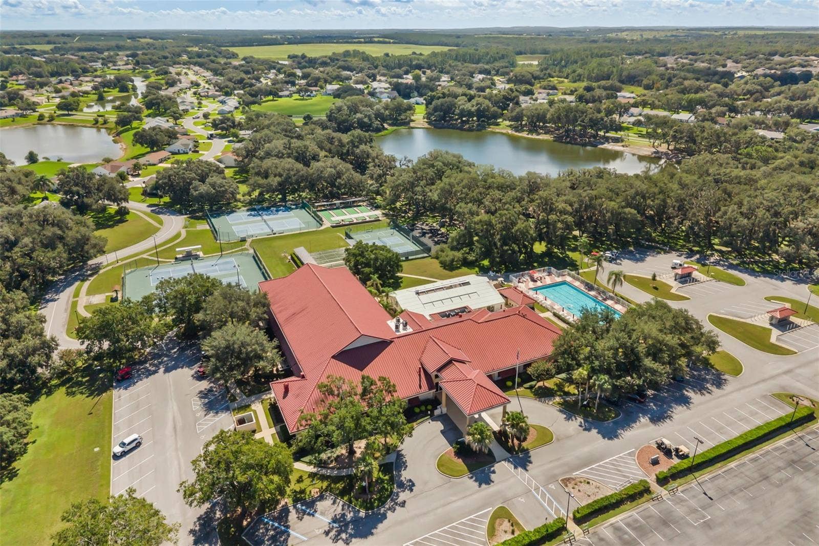 Clubhouse with outdoor pool, tennis, pickle ball and bocce ball courts; lakes for catch & release fishing