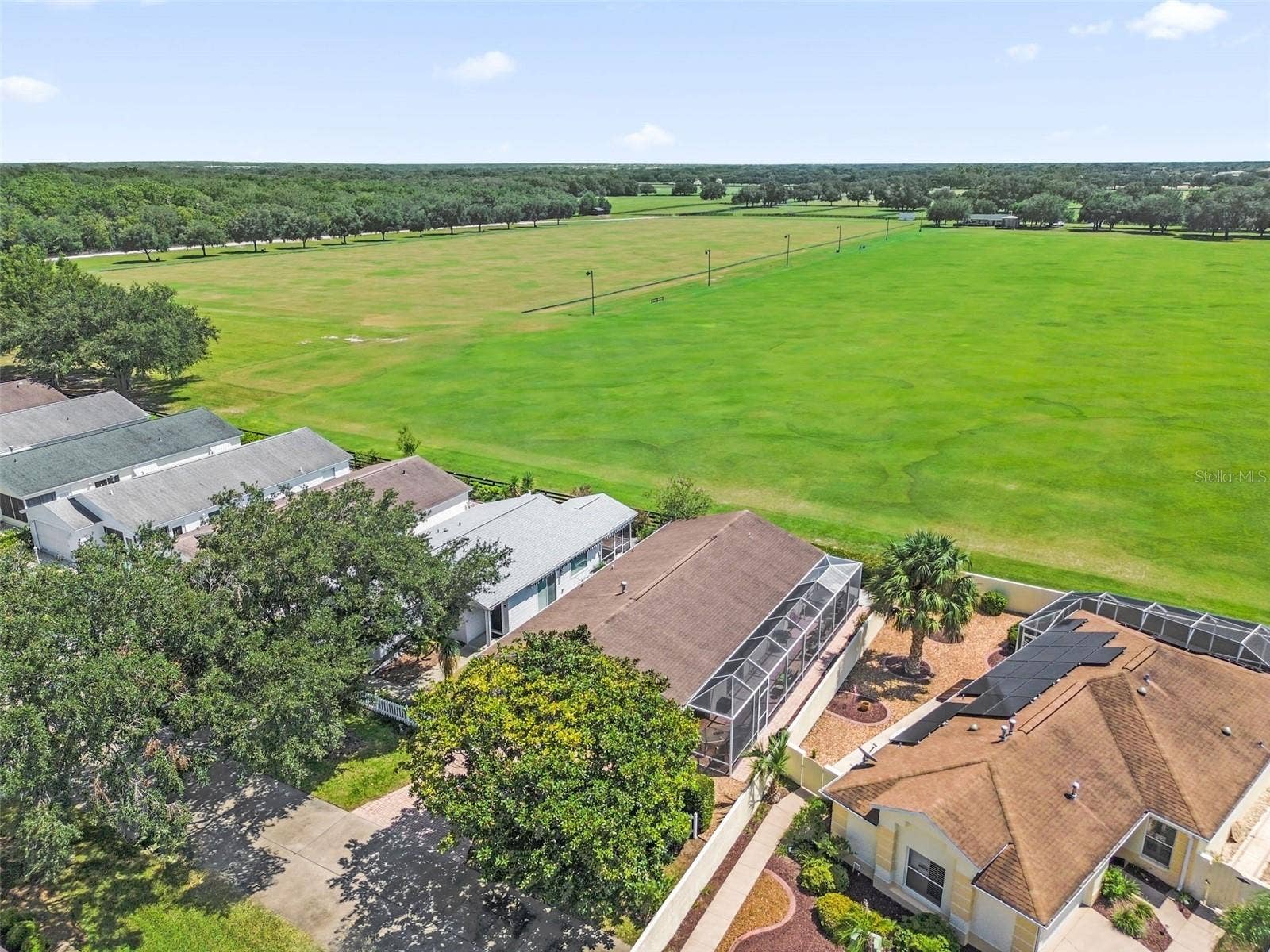 2801 BARBOZA DRIVE, The Villages, FL 32162 Drone view showcasing the home and the adjacent polo field.