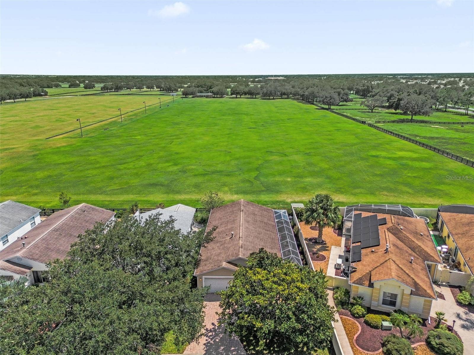 2801 BARBOZA DRIVE, The Villages, FL 32162 Drone view showcasing the home and the adjacent polo field.