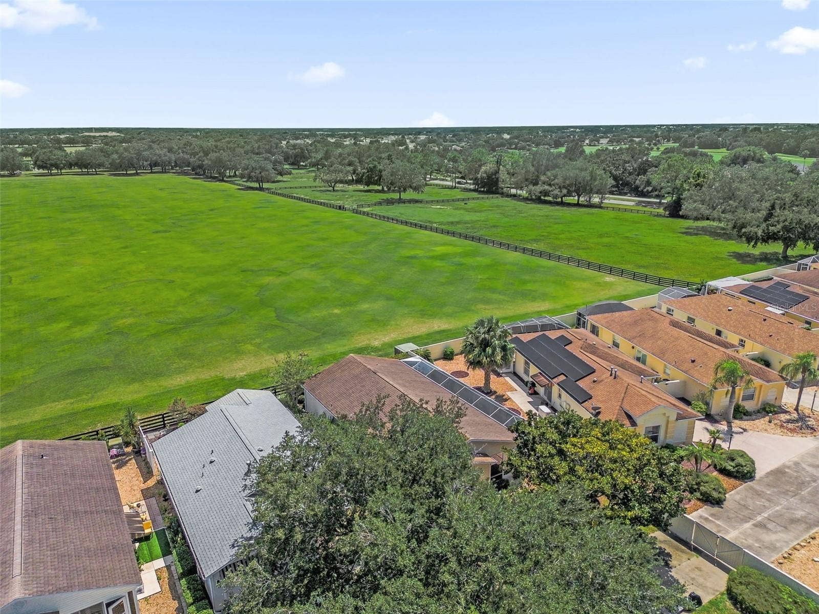 2801 BARBOZA DRIVE, The Villages, FL 32162 Drone view showcasing the home and the adjacent polo field.