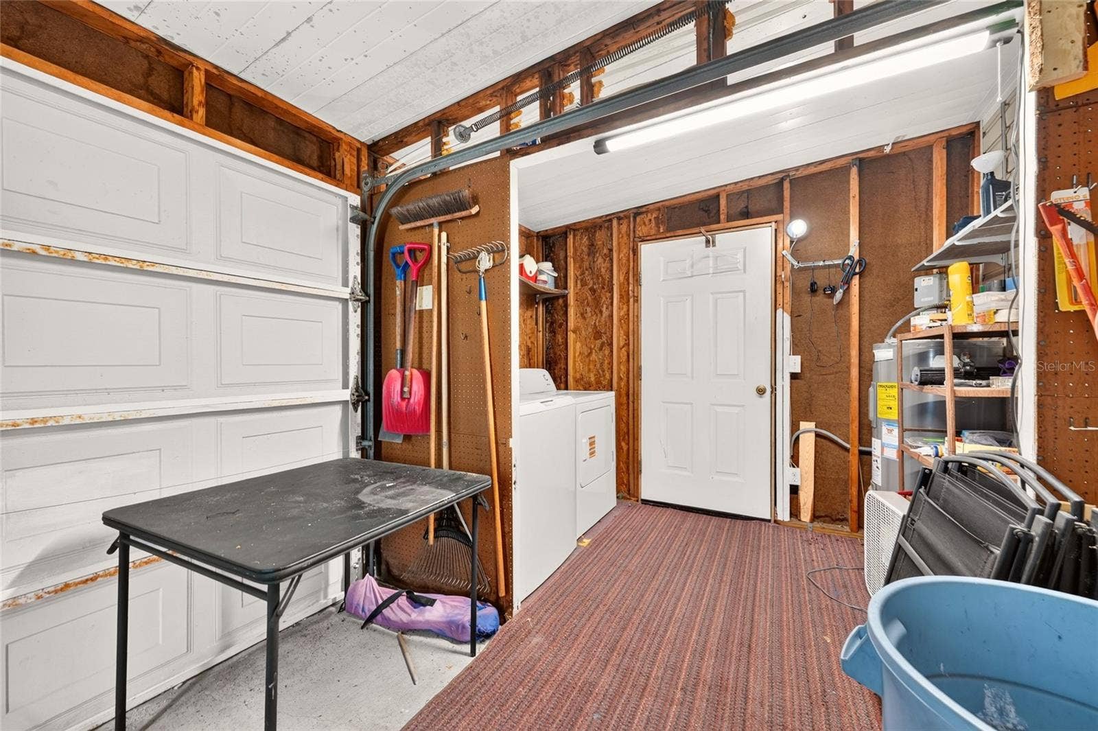 1207 PALMETTO DRIVE, The Villages, FL 32159 Golf Cart Garage looking into Laundry