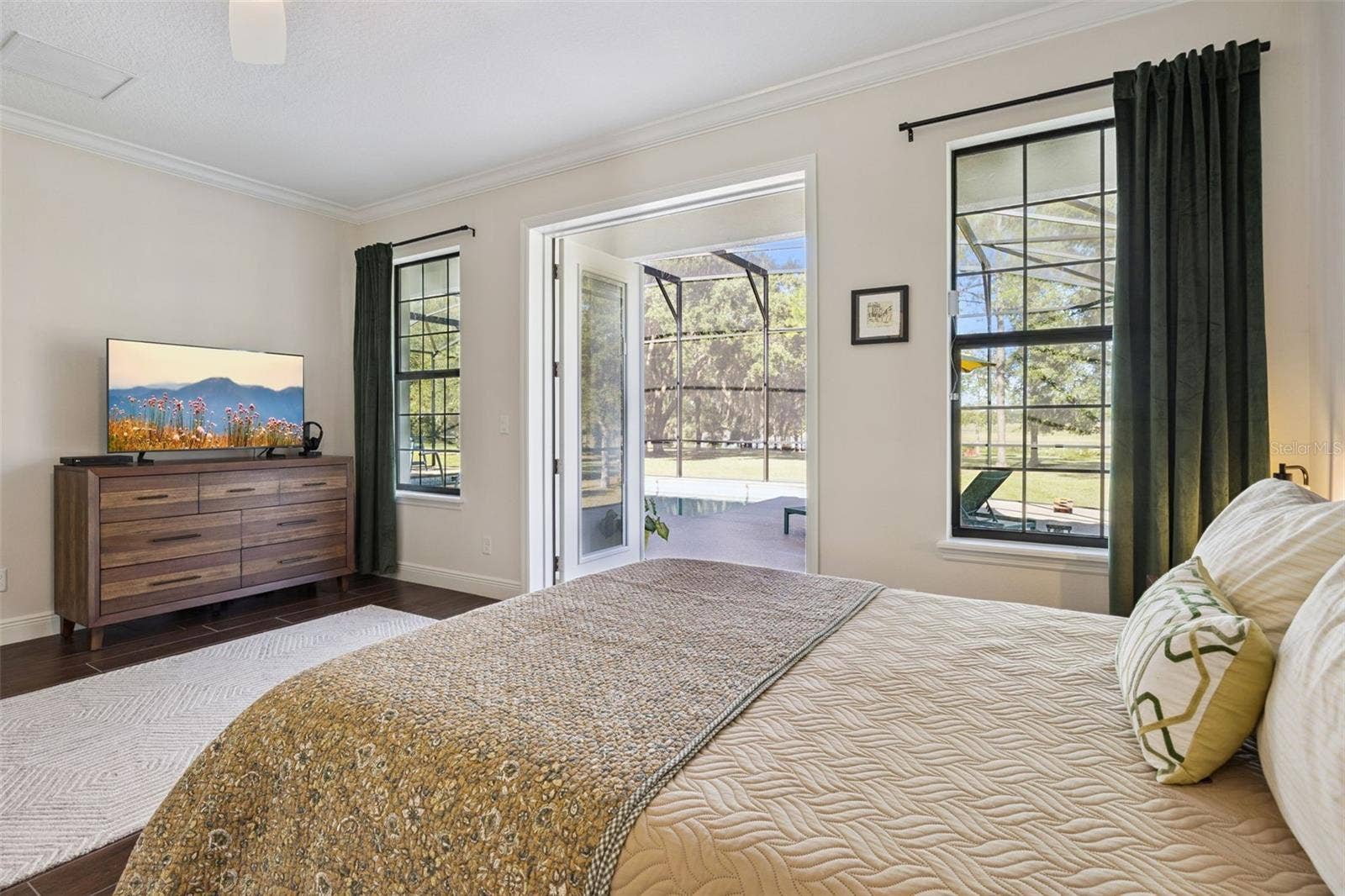 24871 BONSMARA DRIVE, Groveland, FL 34736 Primary Bedroom with French Doors that lead out to the Pool Lanai