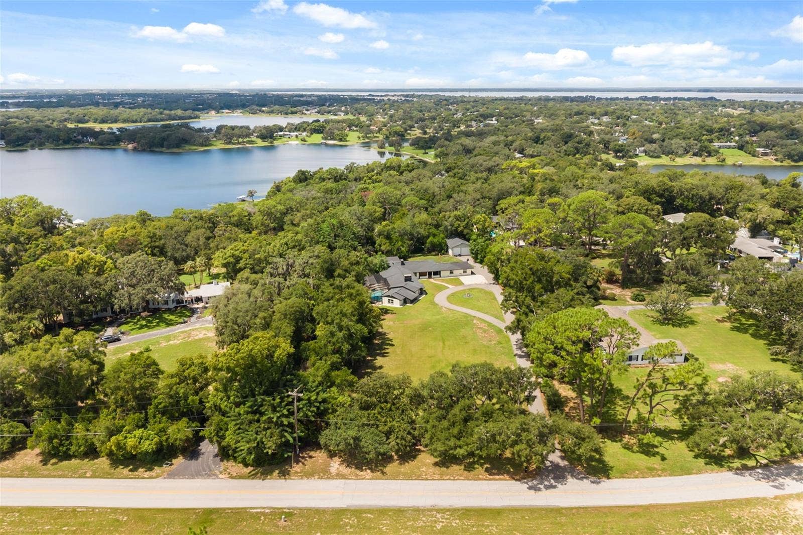 Aerial of the property with views of multiple nearby lakes