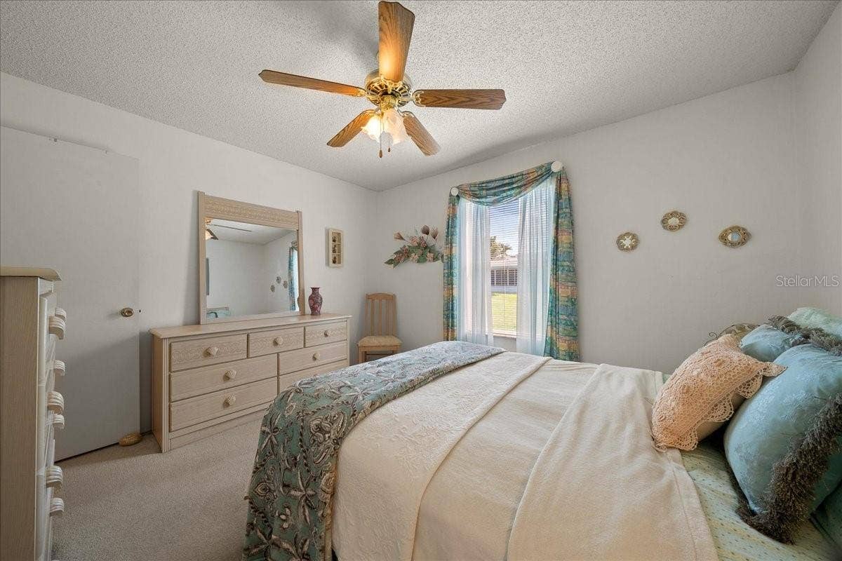1410 SANCHEZ COURT, The Villages, FL 32159 Guest Bedroom Features Ceiling Fan & Built-in Closet