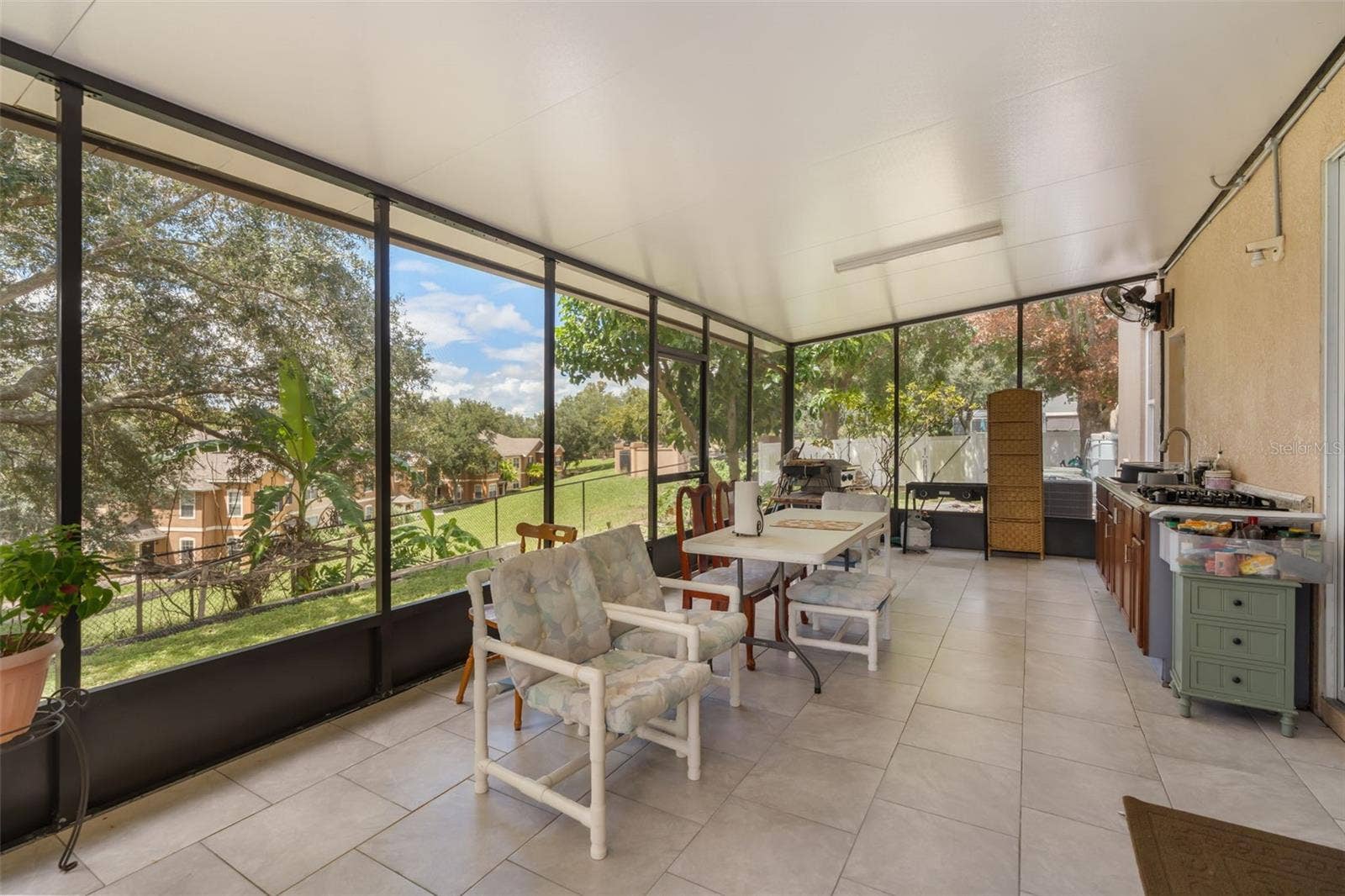 211 HUNT STREET, Clermont, FL 34711 Screened-in patio with plenty of space for outdoor seating and entertaining.
