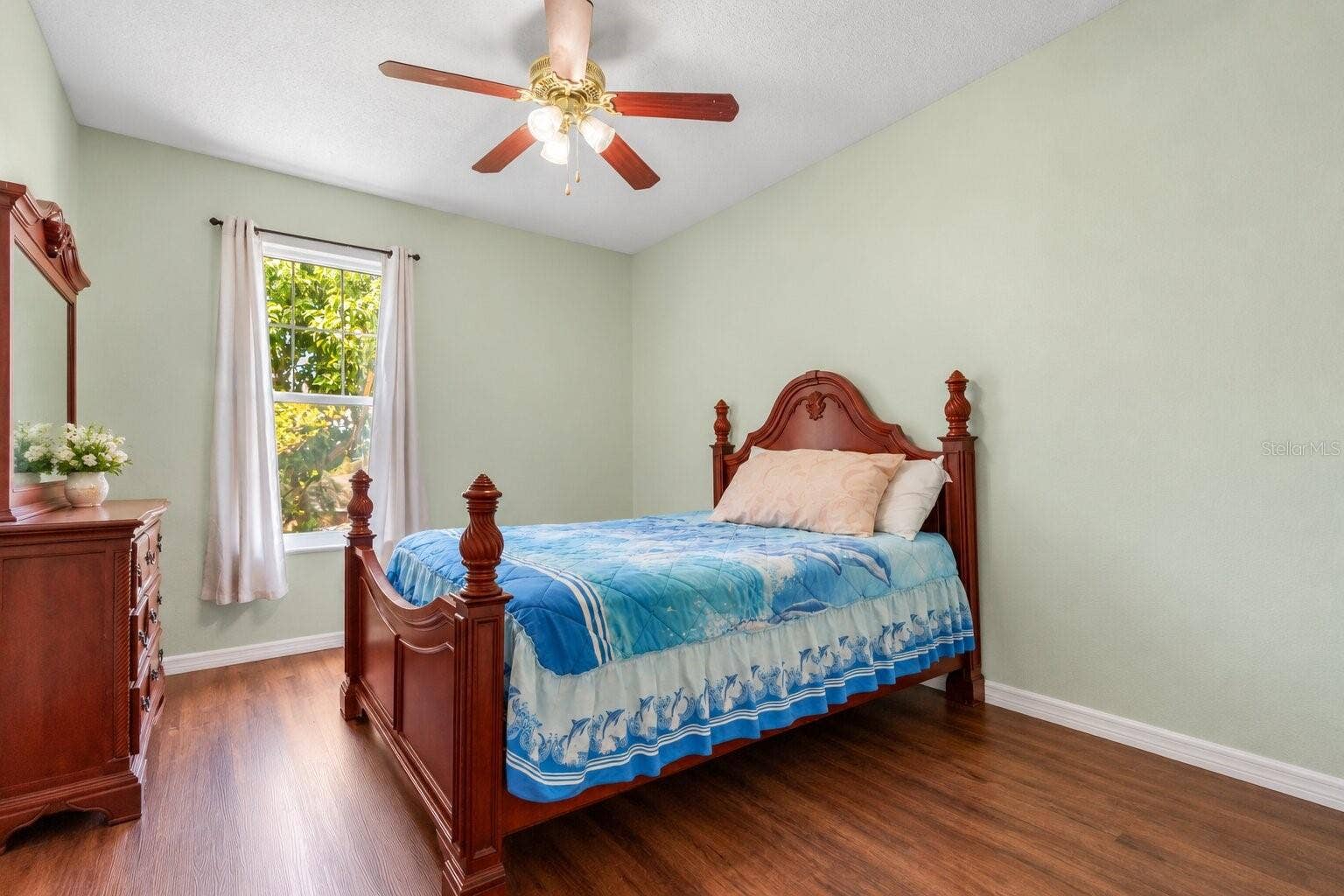 211 HUNT STREET, Clermont, FL 34711 Bedroom downstairs with wood look flooring, ceiling fan, and natural light.