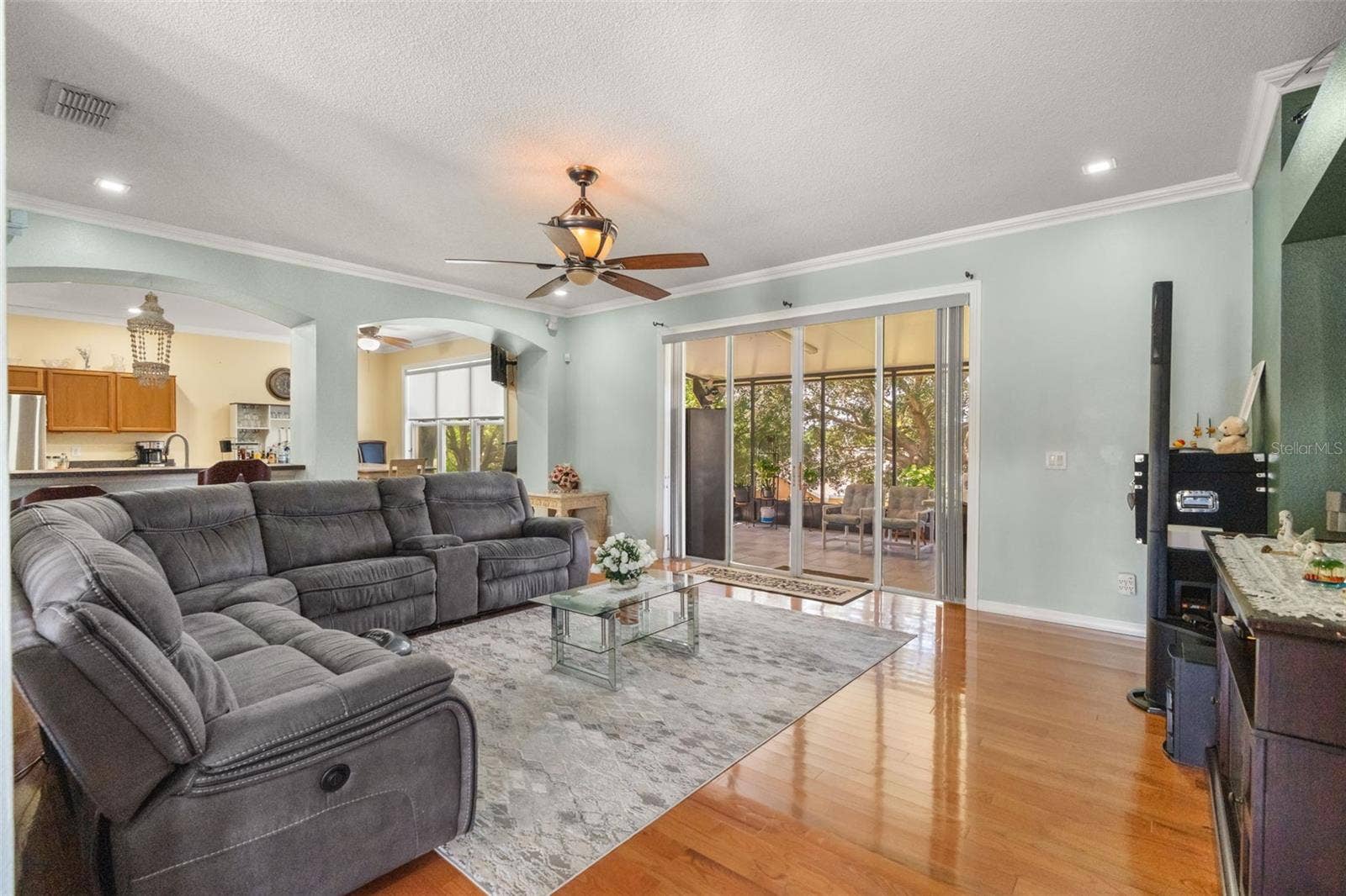 211 HUNT STREET, Clermont, FL 34711 Open-concept family room with spacious seating area and views toward the dining and kitchen spaces.