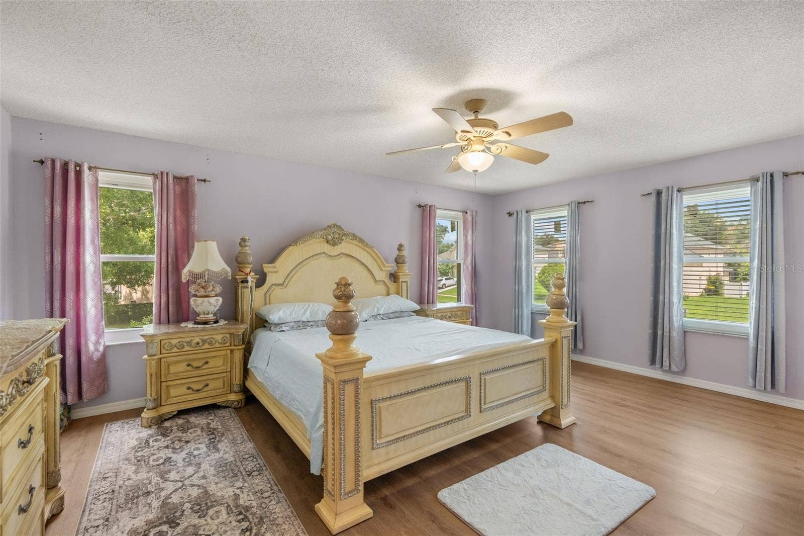 211 HUNT STREET, Clermont, FL 34711 Primary suite with neutral finishes, ceiling fan, and abundant natural light.