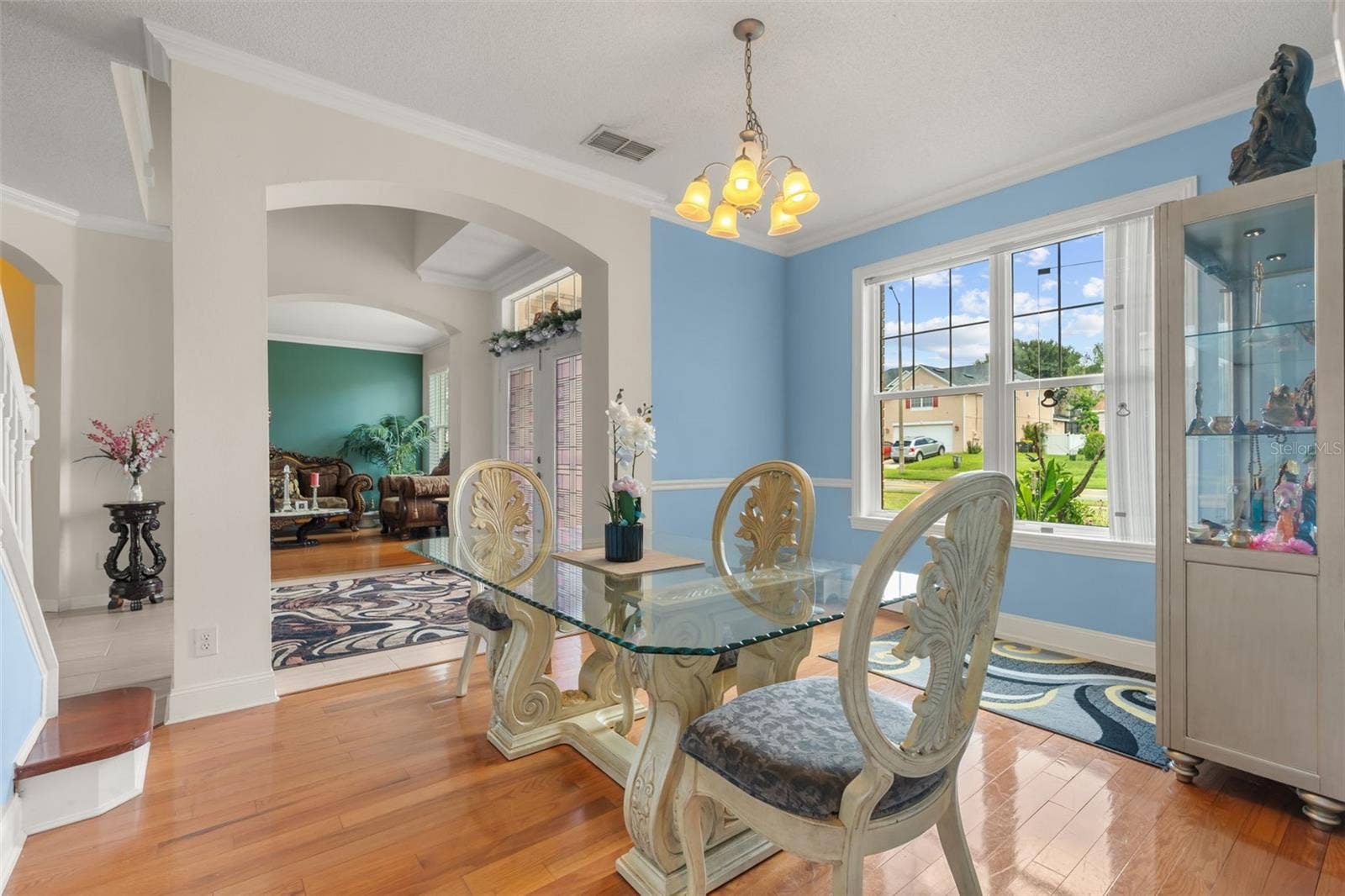 211 HUNT STREET, Clermont, FL 34711 Bright dining area with large windows, elegant architectural details, and plenty of natural light.