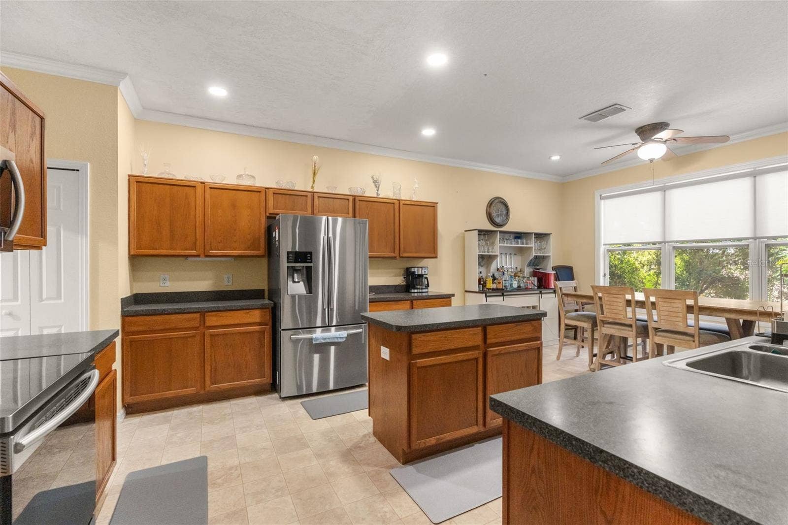 211 HUNT STREET, Clermont, FL 34711 Spacious kitchen featuring stainless steel appliances, abundant cabinets, and a functional layout.