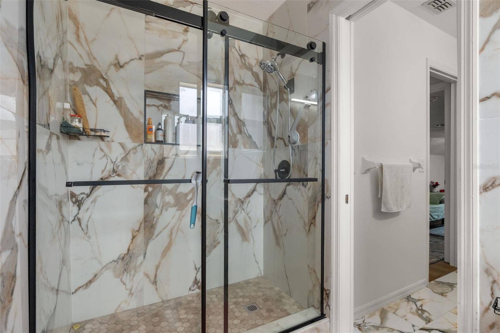 211 HUNT STREET, Clermont, FL 34711 Bathroom with glass-enclosed shower and modern tile finishes.