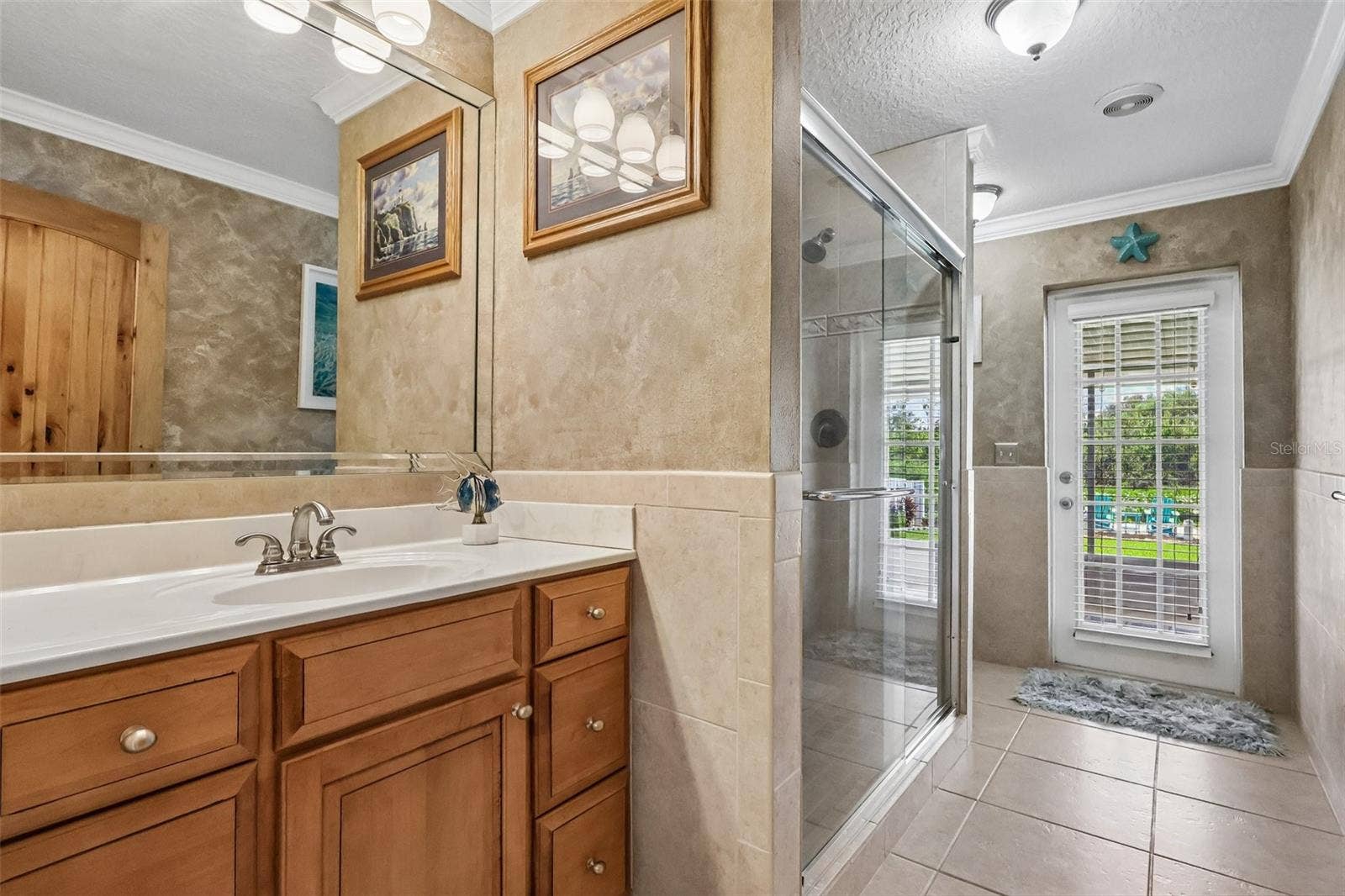 28116 LOIS DRIVE, Tavares, FL 32778 exquisite Guest Bathroom with door to screened in patio runs along the back of house