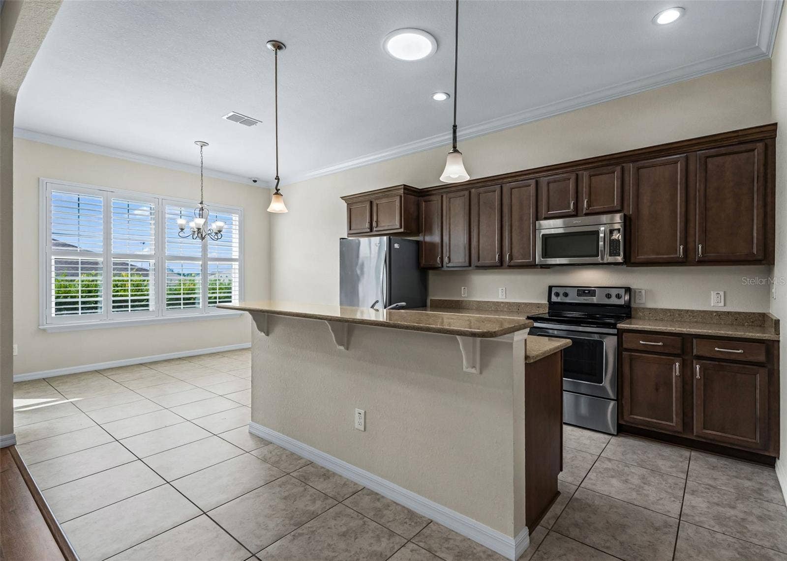 Open Kitchen w/Generous Breakfast bar & Crown molding