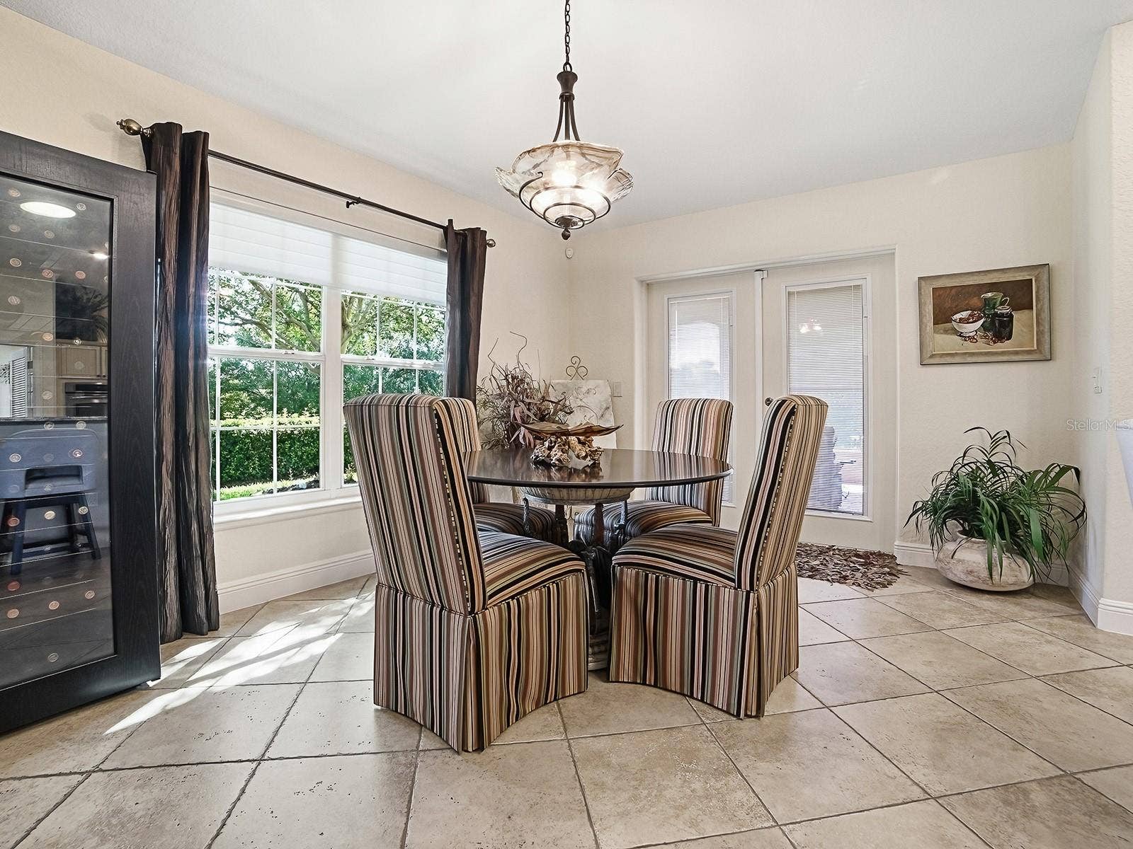 EAT IN KITCHEN WITH NATURAL SUNLIGHT POURING IN AND DOORS TO THE SIDE LANAI