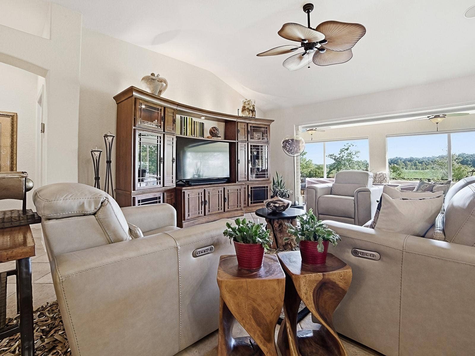 LIVING ROOM AREA WITH VIEWS TO THE ENCLOSED LANAI